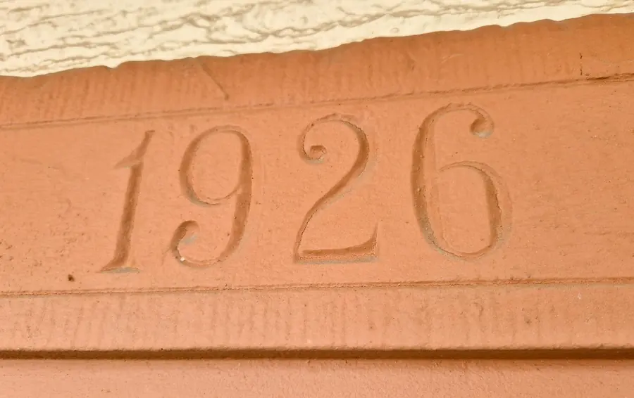 The year 1926 carved into the red sandstone lintel above the front door